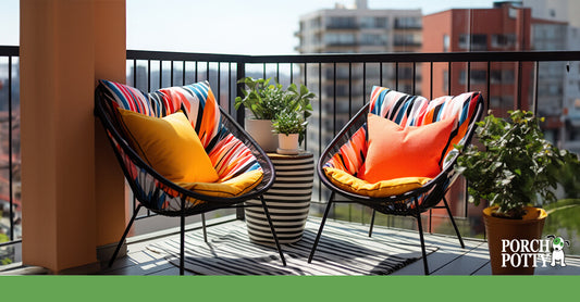 Two chairs with vibrant cushions are set up on a cosy balcony